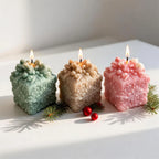 Snowflake gift-box castings arranged beside holiday greenery