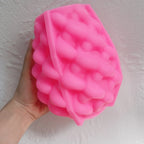Pink silicone mold with dense curved petal relief for sculptural wax candles