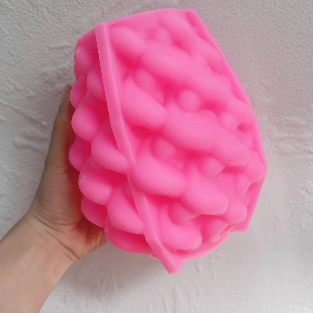 Pink silicone mold with dense curved petal relief for sculptural wax candles