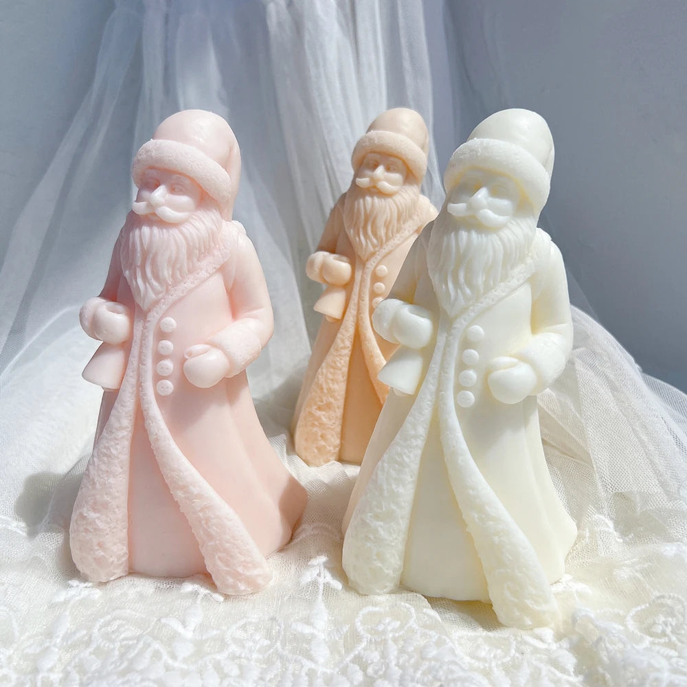 Pink cream and tan Santa figures with sweeping coat hems