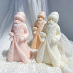 Pink cream and tan Santa figures with sweeping coat hems