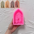 Pink silicone crescent lantern arch mold held in a hand