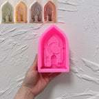 Pink silicone crescent lantern arch mold held in a hand