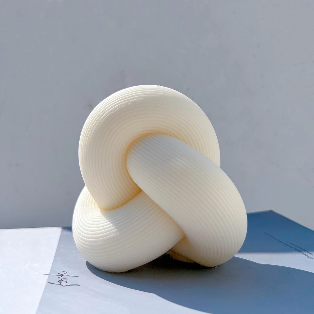 Cream sculptural tube knot candle