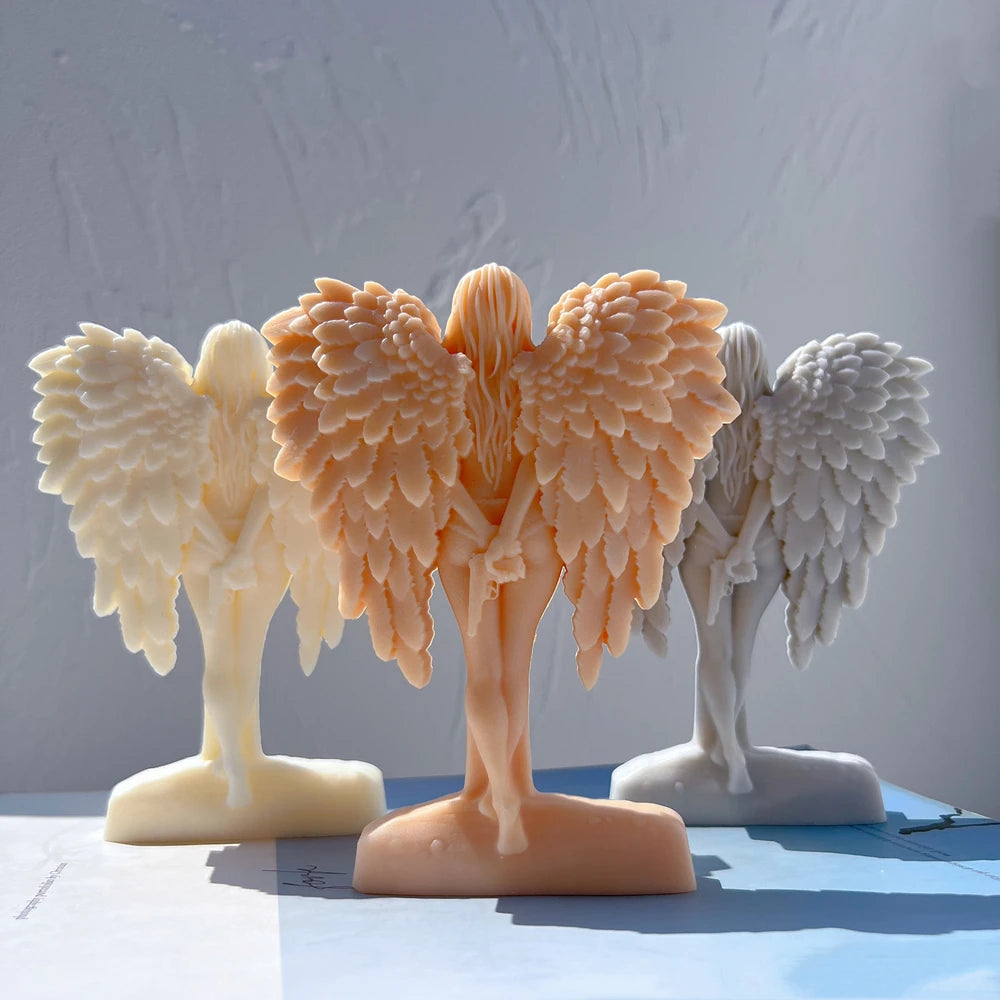 Winged figure castings with broad layered feather relief