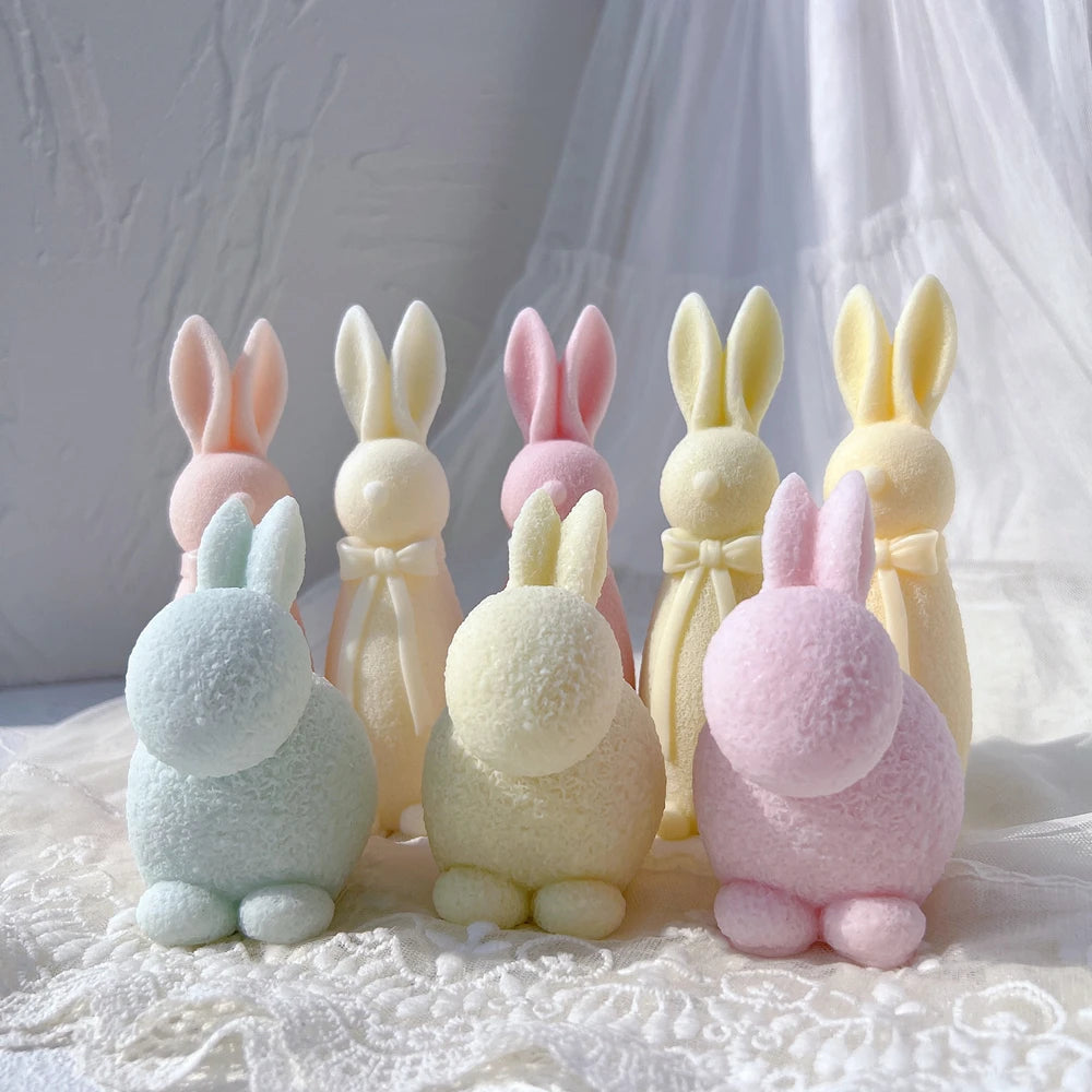 Rear views of crouching rabbits beside standing examples