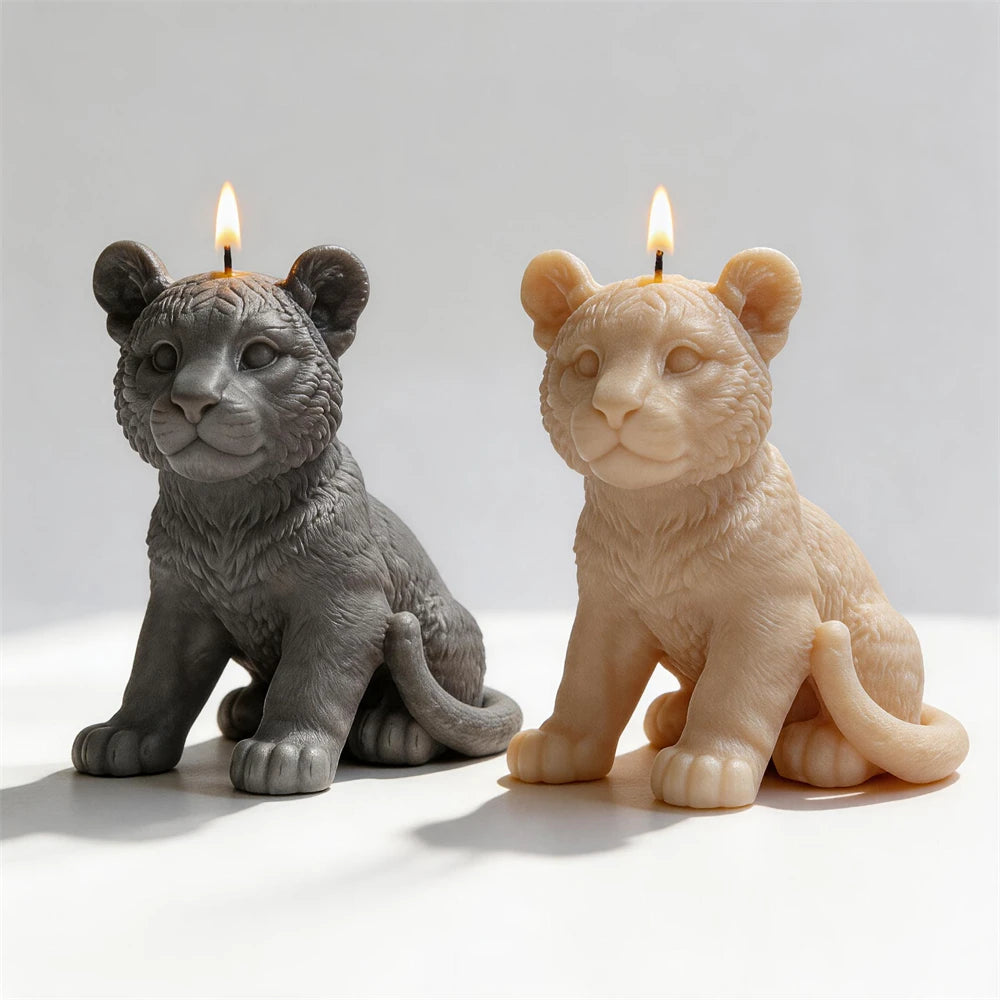 Angled seated tiger cub candles showing their tails beside the hind legs