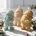 Three gnome candles holding gingerbread men
