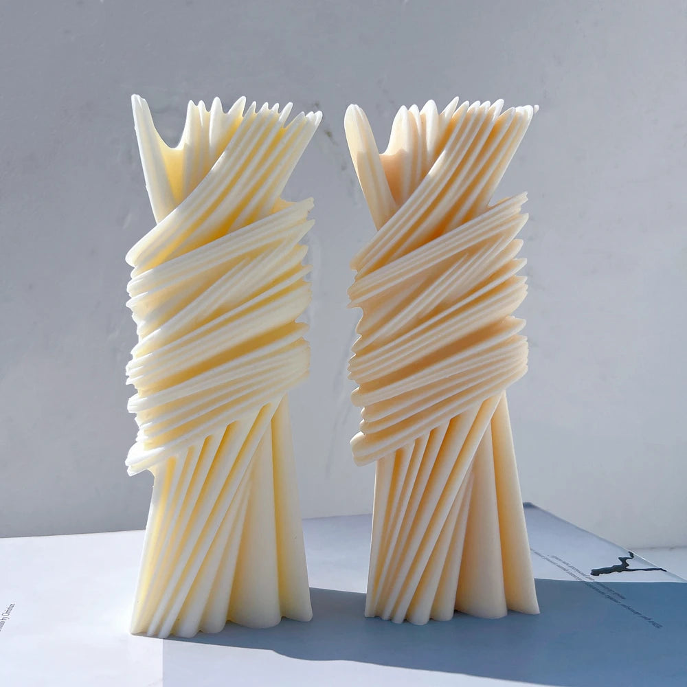 Two wrapped ribbon pillar castings with diagonal ridges and fanned ends