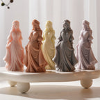 Several full-length dress figures in contrasting wax colors