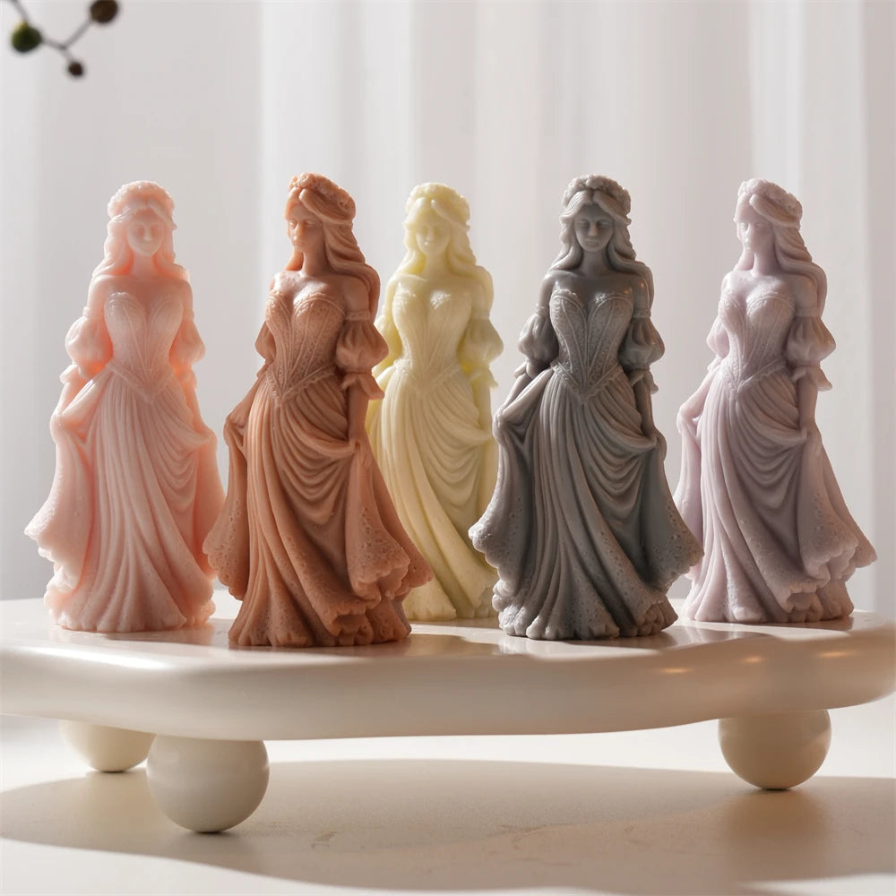 Several full-length dress figures in contrasting wax colors