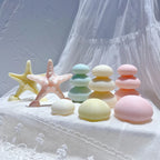 Textured starfish beside stacked coastal candle forms