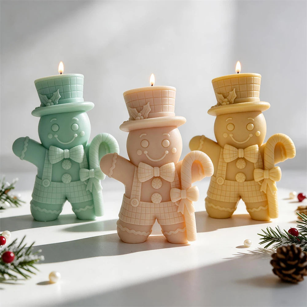 Top-hat gingerbread man candles holding candy canes