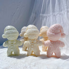 Front and rear views of winter gingerbread candles with knitted hats