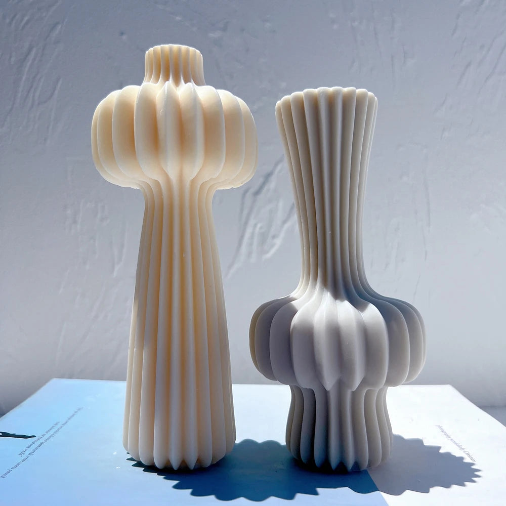 Tall top-bulb and lower-bulb fluted castings displayed together