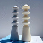 Blue and cream geometric pillar figures with rounded disc sections
