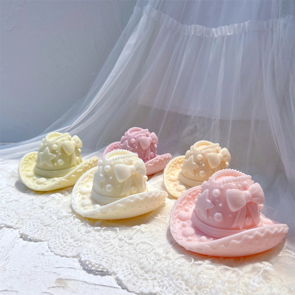 Pastel gingerbread-style cowboy hat candle castings