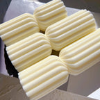 Group of ribbed double-section candles laid on their sides
