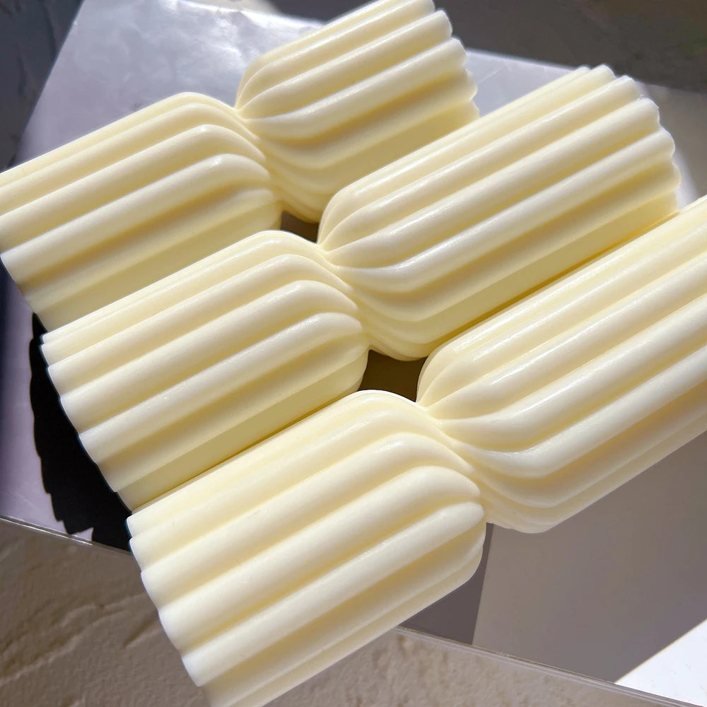 Group of ribbed double-section candles laid on their sides