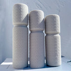 Cream and gray textured pillar castings in different heights