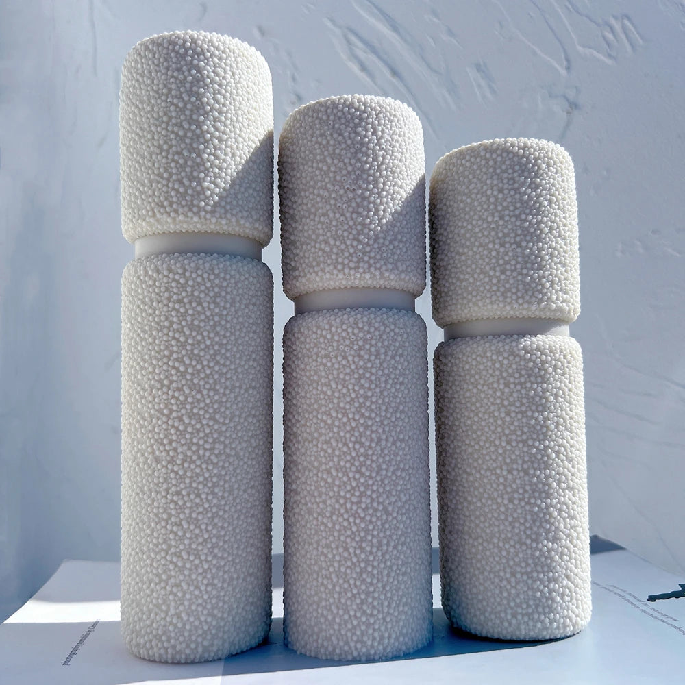 Cream and gray textured pillar castings in different heights