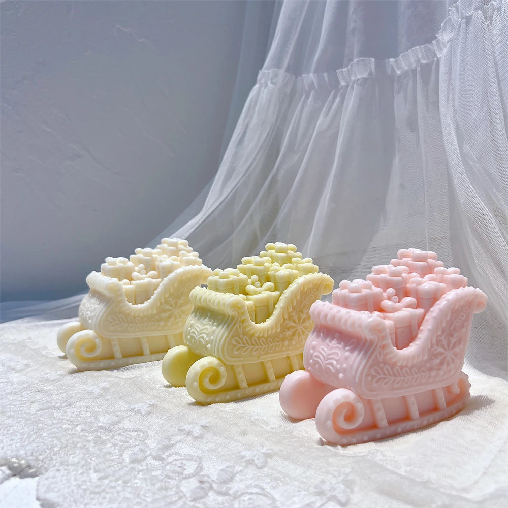 Gift sleigh candles showing front and side scrollwork decoration