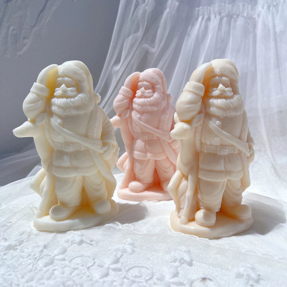 Three standing Santa castings with beards and winter coats