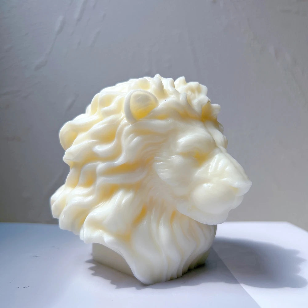 Side profile of white lion-head sculpture showing nose and flowing mane