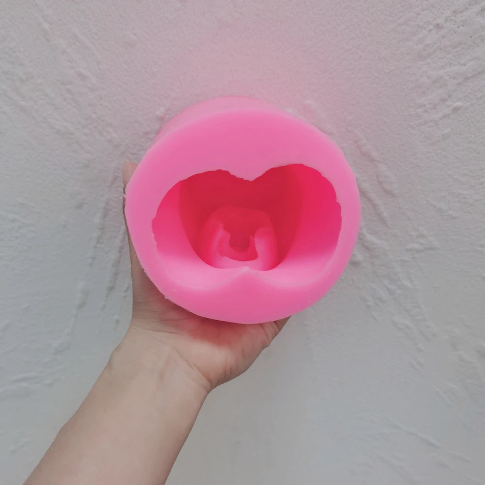 Pink pregnancy torso silicone mold viewed into its cavity