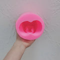 Pink pregnancy torso silicone mold viewed into its cavity