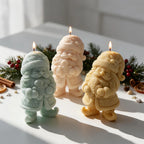 Group of gnome candles beside Christmas decorations