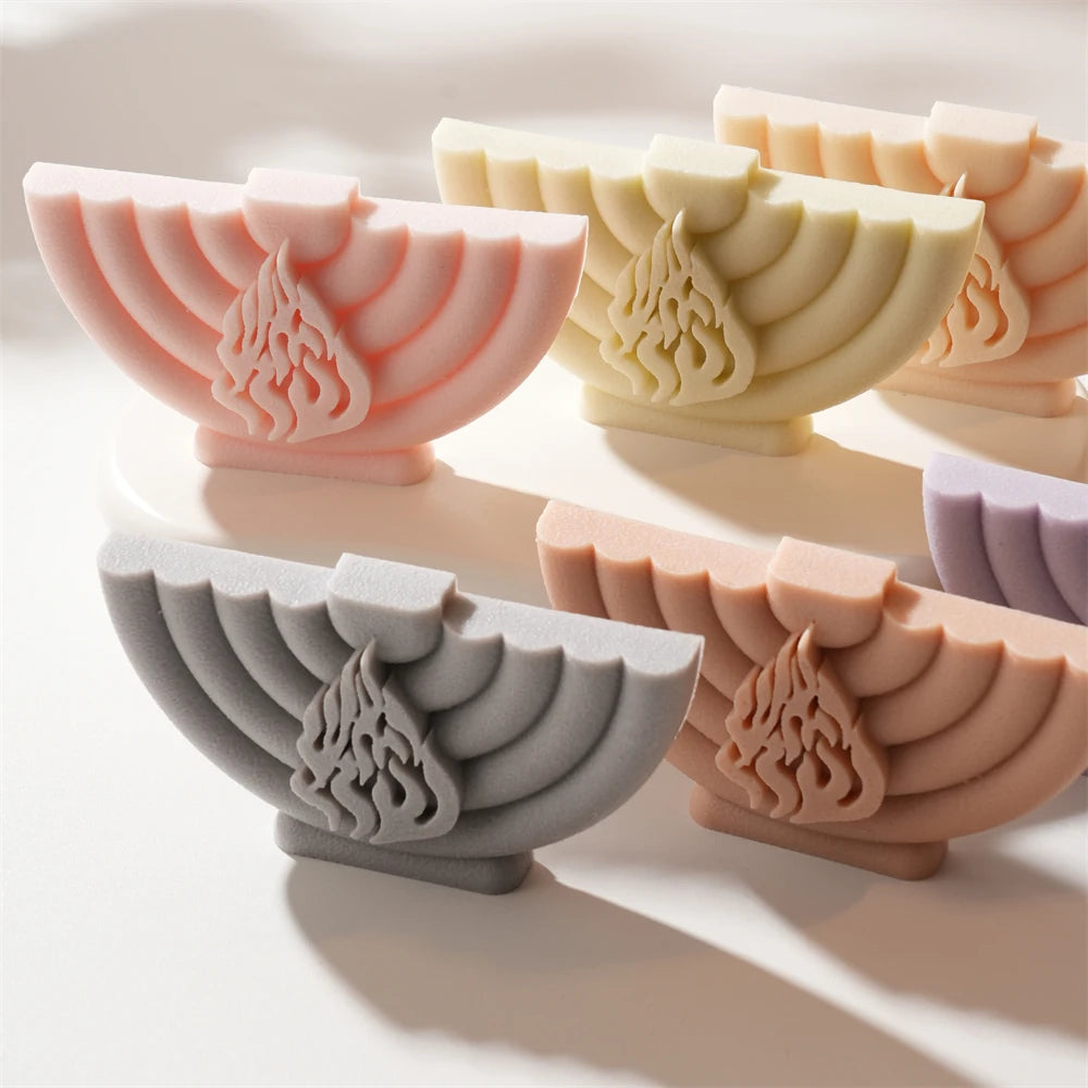 Pastel menorah reliefs with curved branch patterns
