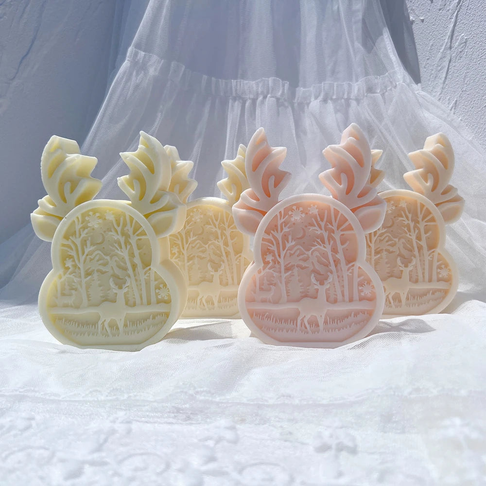 Four forest-scene relief castings in pastel colors