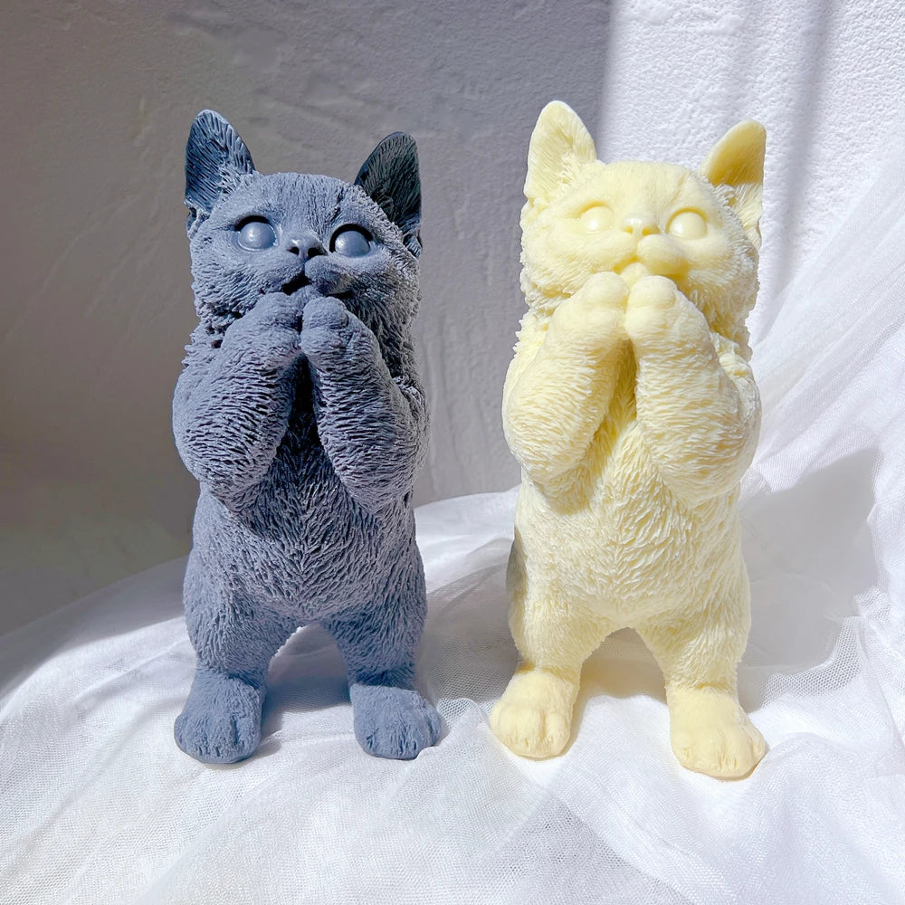 Front view of standing cat castings with raised paws and rounded muzzles