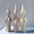 Three twisted spindle castings showing flared bases and pointed tips