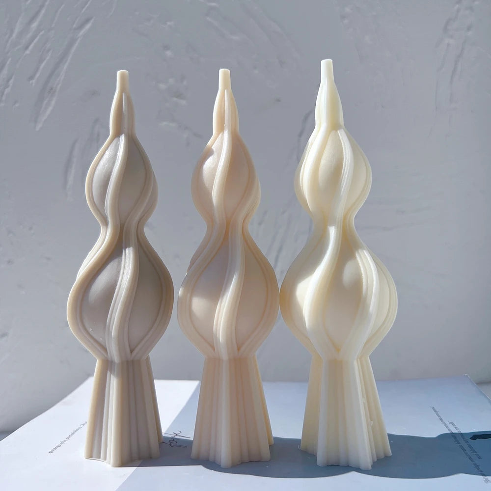 Three twisted spindle castings showing flared bases and pointed tips