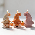 Front and rear views of bat hat gnome candles with curled tips