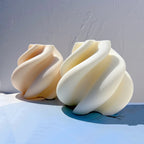 Angled view of two broad folded spiral castings