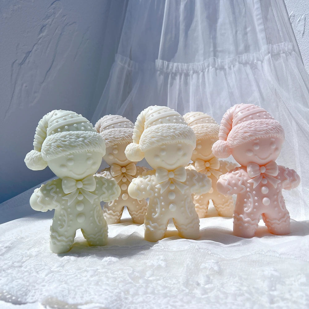 Gingerbread man candle with pom-pom knit hat and buttoned coat