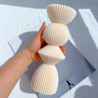 Large stacked geometric ribbed casting held in a hand