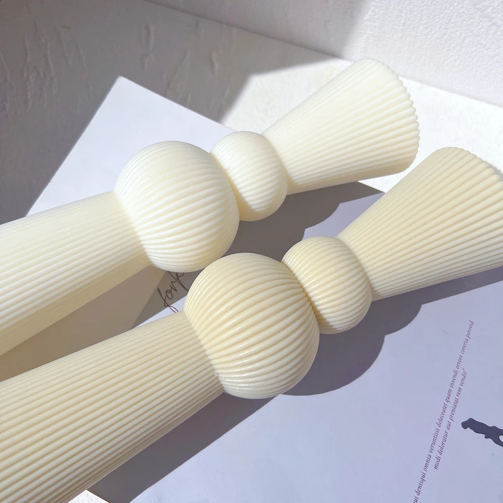 Two ribbed sphere-and-column castings laid flat