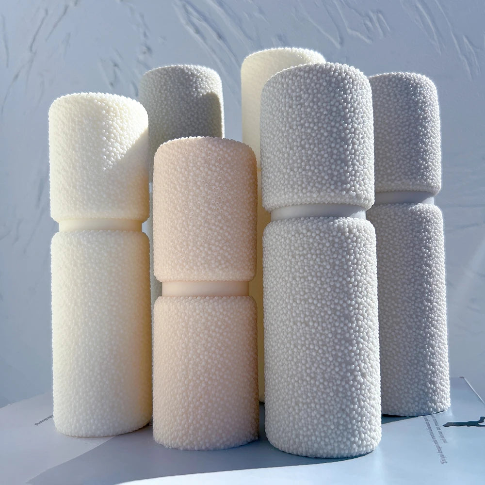 Pebble-textured pillar castings arranged in a group