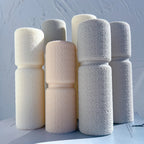 Pebble-textured pillar castings arranged in a group