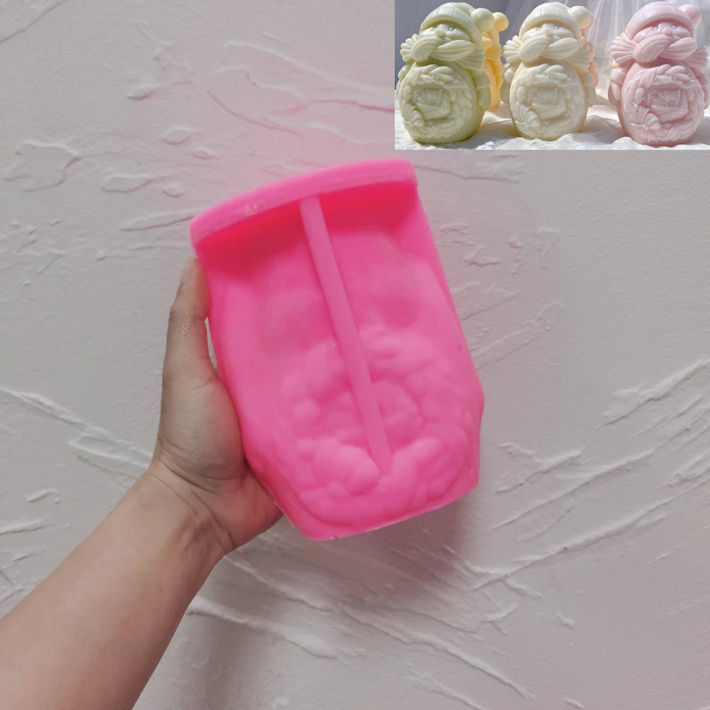 Pink silicone hugging snowman mold with matching casting examples