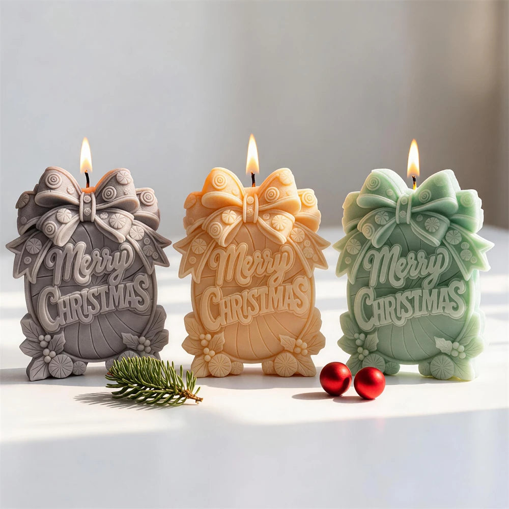 Three Merry Christmas sign candles with large bows and wreath borders