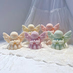 Group of pastel praying angel castings with joined hands and spreading wings
