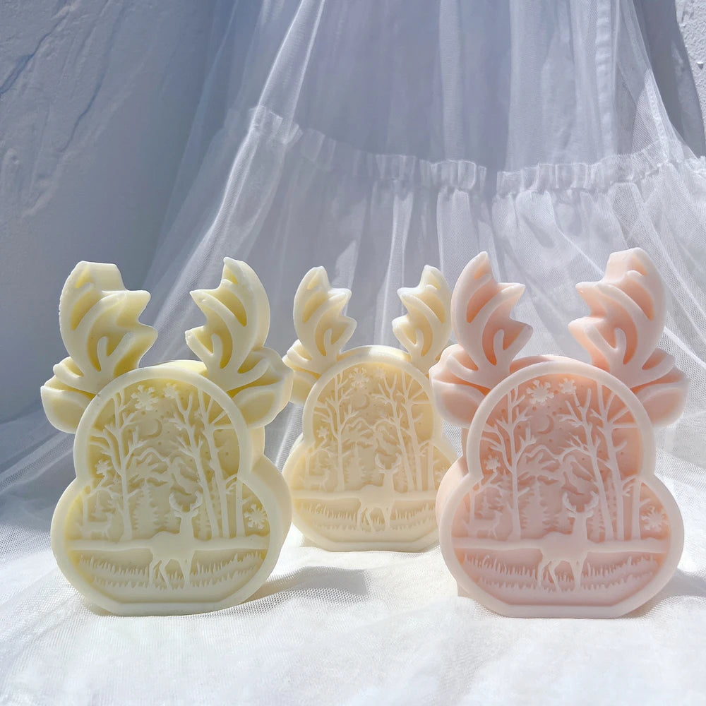 Several deer-and-forest relief castings viewed from the front