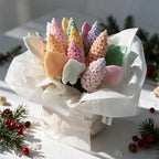 Side angle of a pastel lilac and leaf bouquet wrapped in white paper
