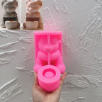 Pink silicone ram and cup holder mold beside finished casting examples
