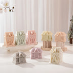 Gingerbread house candles in two roof and building shapes in pastel colors